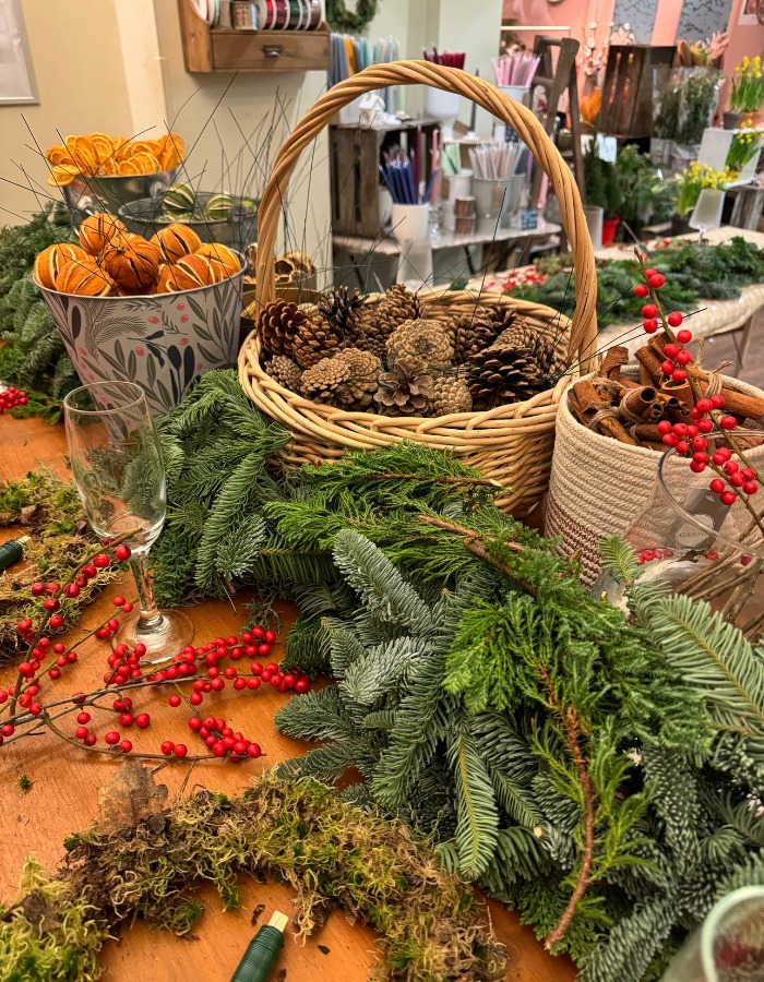 Fresh foliage, berries and natural materials prepared for a Christmas wreath workshop in Bristol