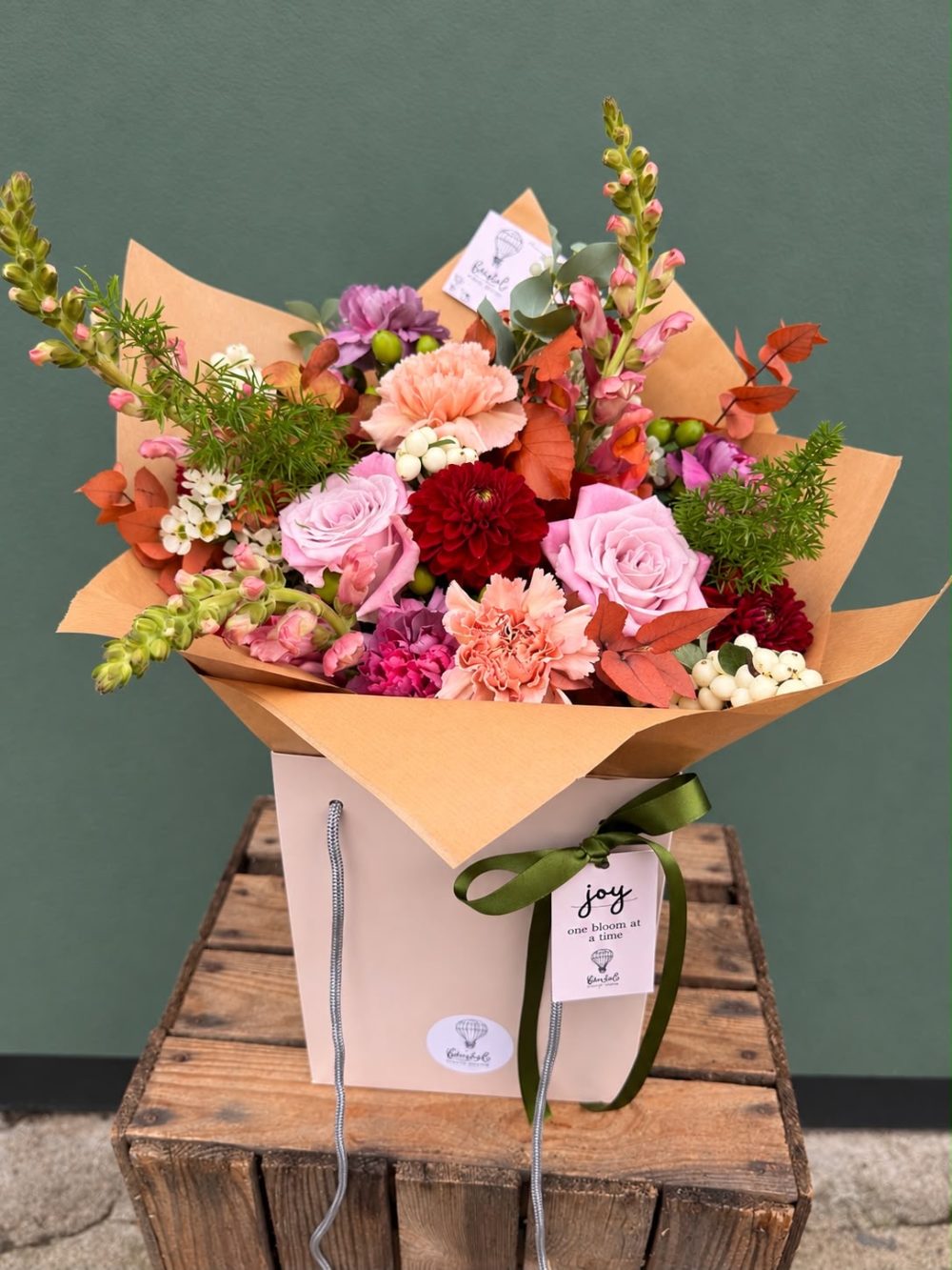 The Pumpkin Spice autumn flower bouquet by Bristol Floral Design — dahlias, roses, snapdragons and autumnal foliage in a gift bag