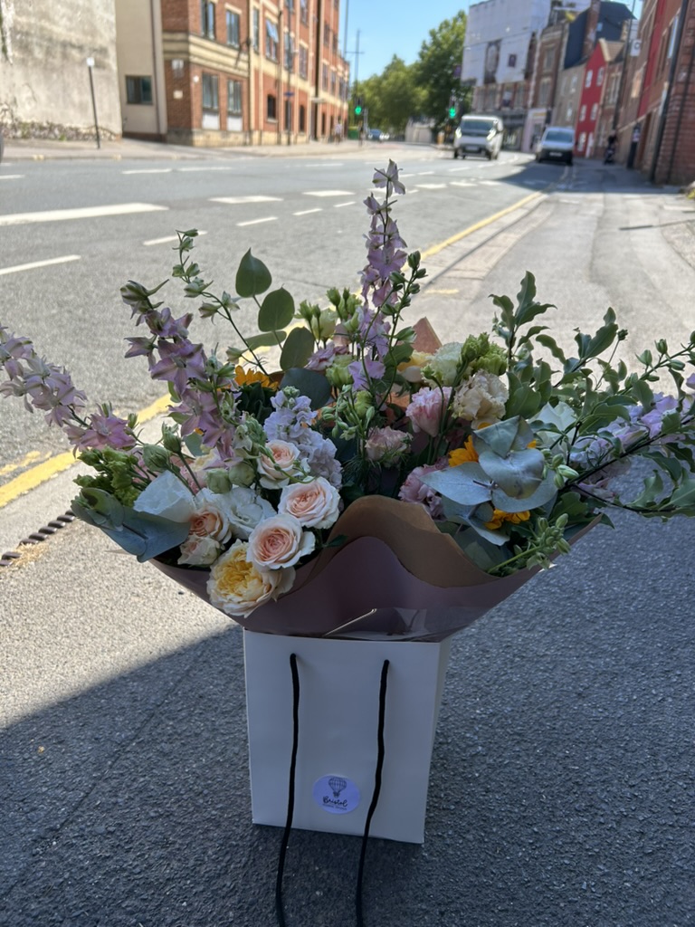 Bristol Floral Design bouquet hand-delivered to a doorstep in Bristol, with the BFD gift bag and delivery van