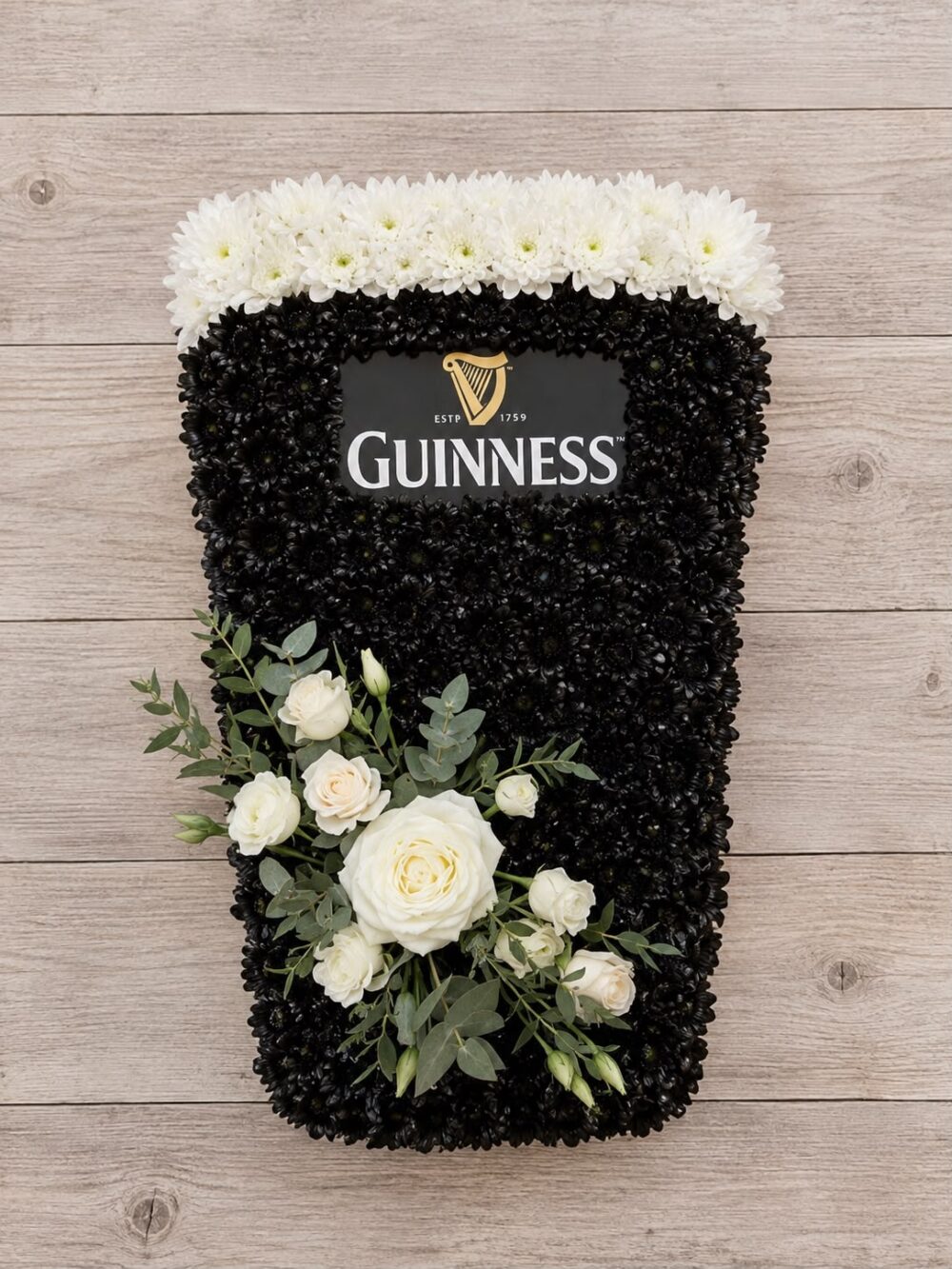 Pint of Guinness funeral tribute in black and white chrysanthemum with ivory roses and eucalyptus, by Bristol Floral Design